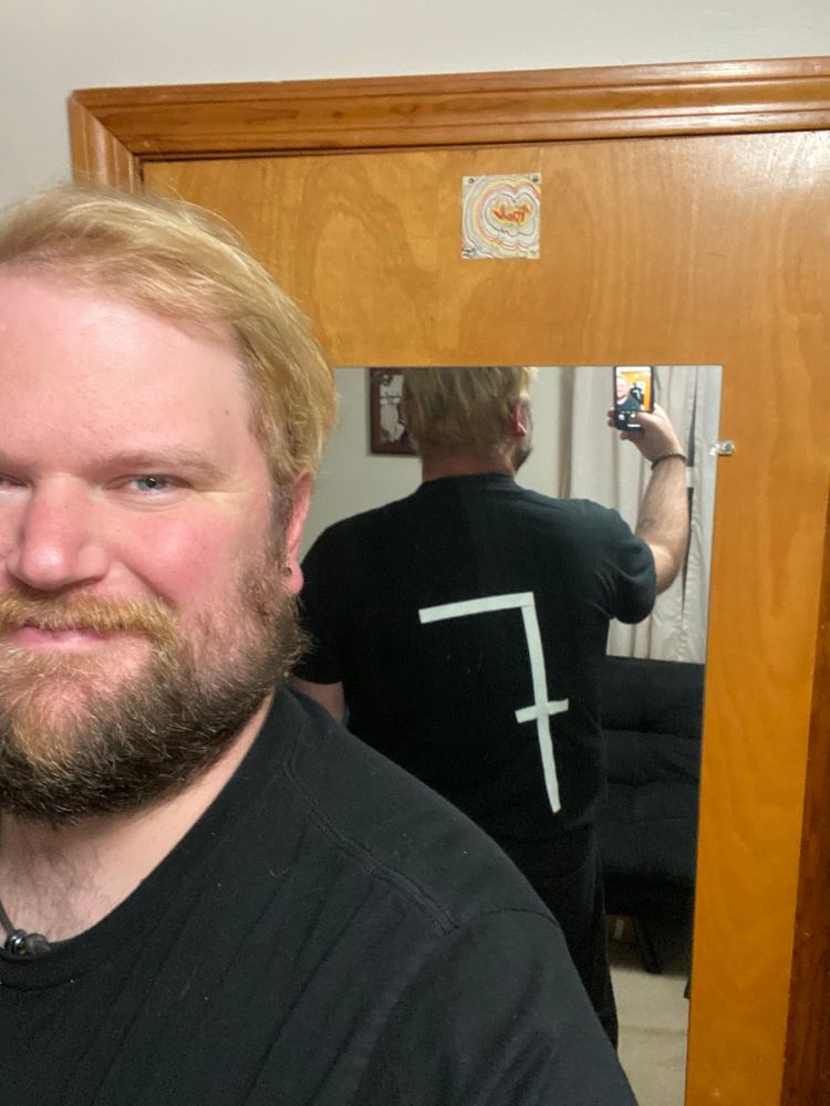 Me showing the same all-black outfit with a 7 taped on the back