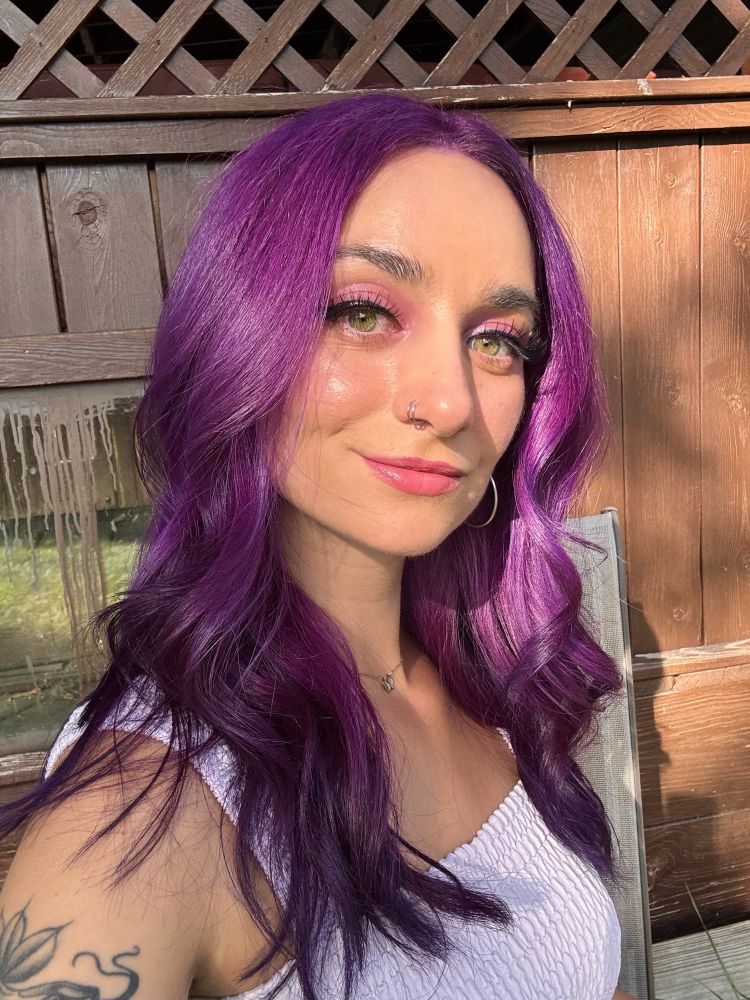 Jupie selfie taken outside showing off her freshly dyed purple hair. 