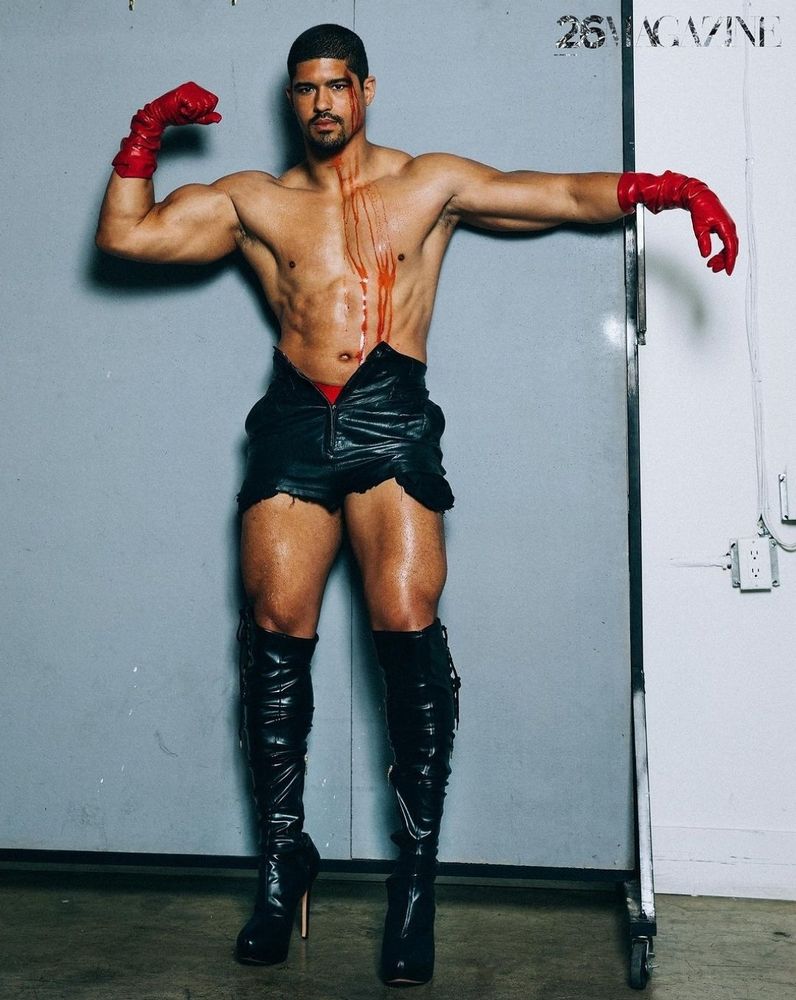 anthony bowens in latex gloves, leather shorts, and spike heel knee high boots bleeding from his head down his chest