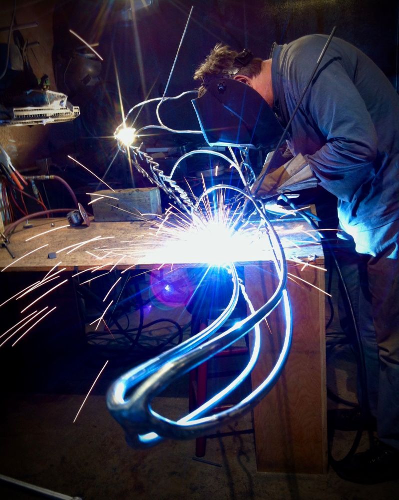 @jeffdeboer.bsky.social welding the steel wire tail section for the nodosaur Borealopelta markmitchelli fossil sculpture. The sculpture was commissioned by the Royal Tyrrell Museum of Palaeontology, and it was carefully installed around the fossil. I was so lucky to apprentice with Jeff on this project of a lifetime, learning to weld big metal 🙏