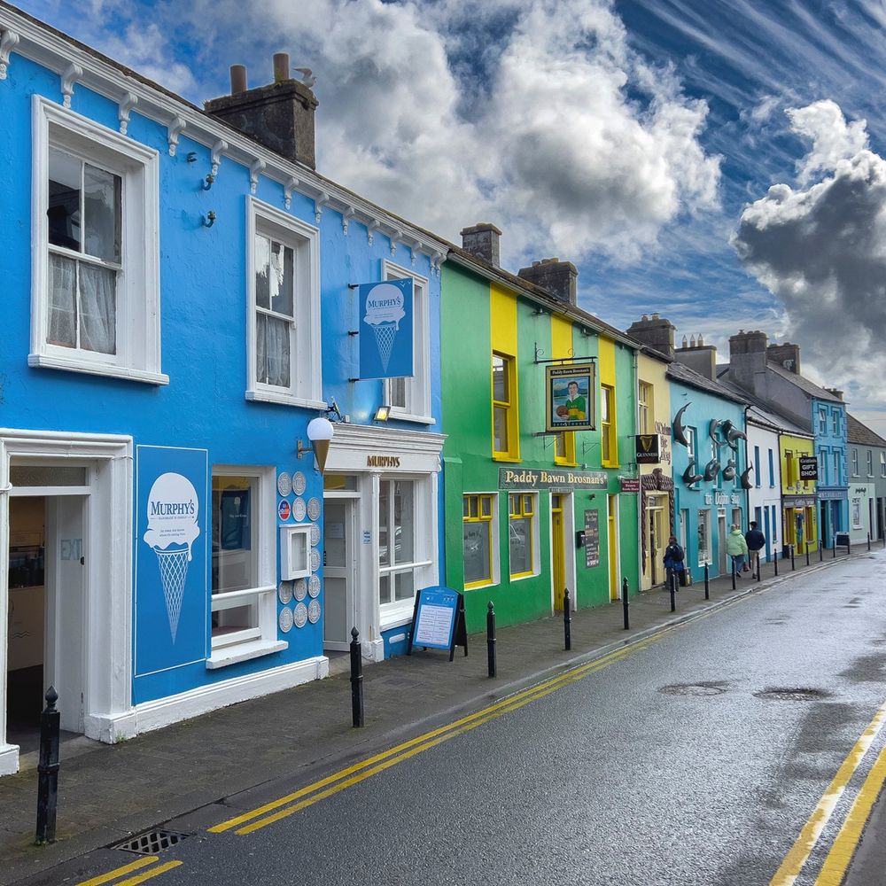 A view of colorful shops in a small town in Ireland.