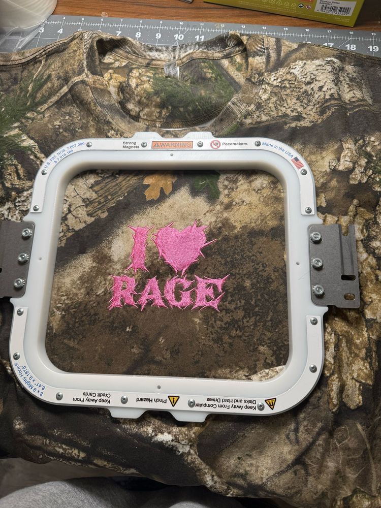 embroidered metal font that says I heart rage on a camo t shirt 