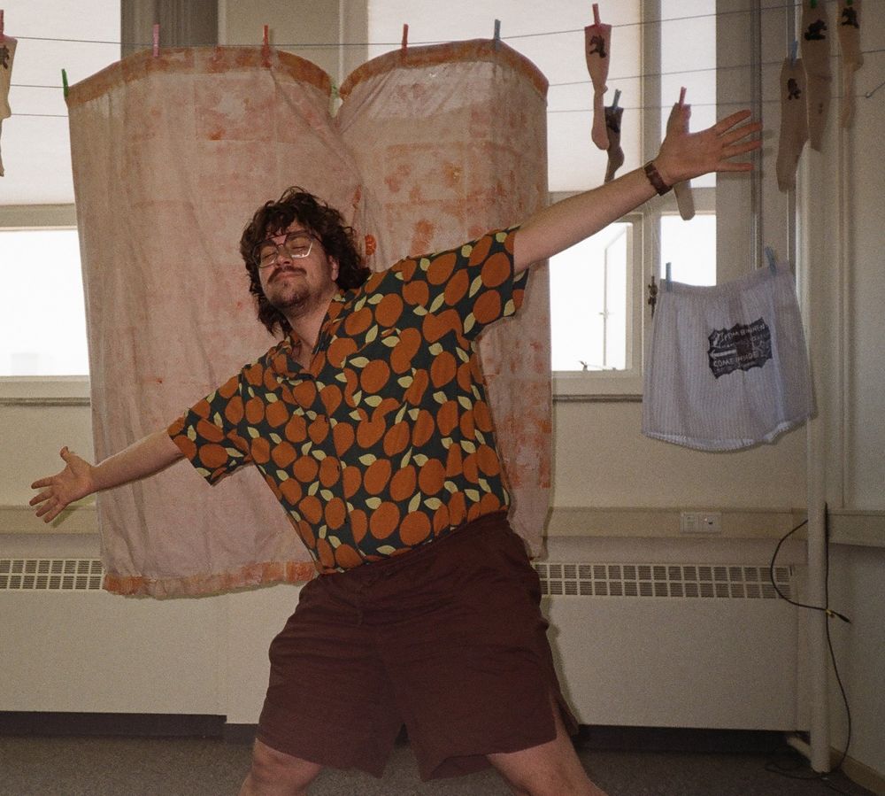 a picture of me, arms spread, showing off my graduation work. I have a full moustache and almost full beard now