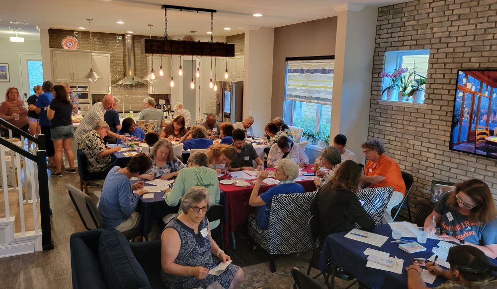 The Lake Nona Democrats writing postcards to unregistered Orange County residents urging them to register to vote.