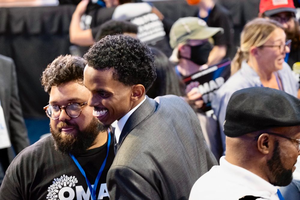 Akhi and Fateh talking to someone at the Convention.