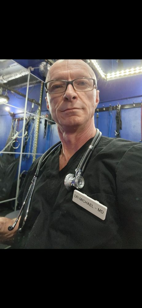 Doc DeCrow wearing black scrubs with a stethoscope 