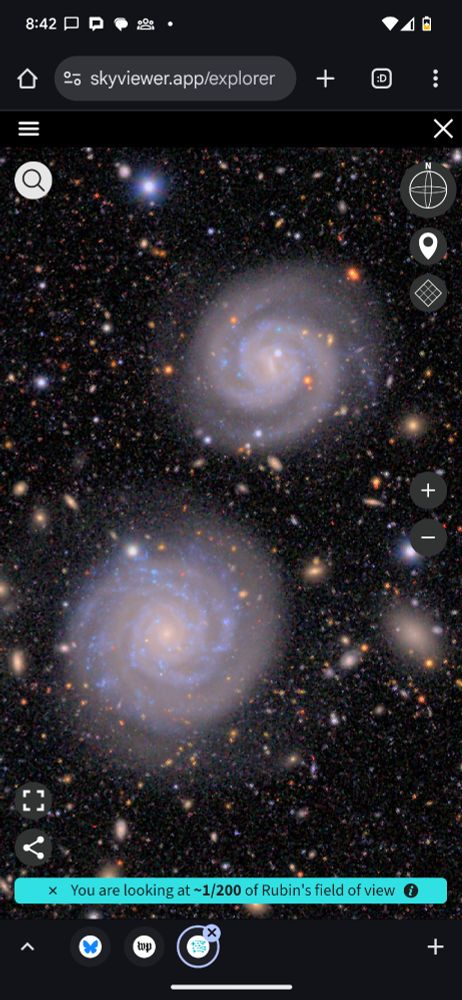 Two beautiful spiral galaxies on a background of a zillion tiny galaxies