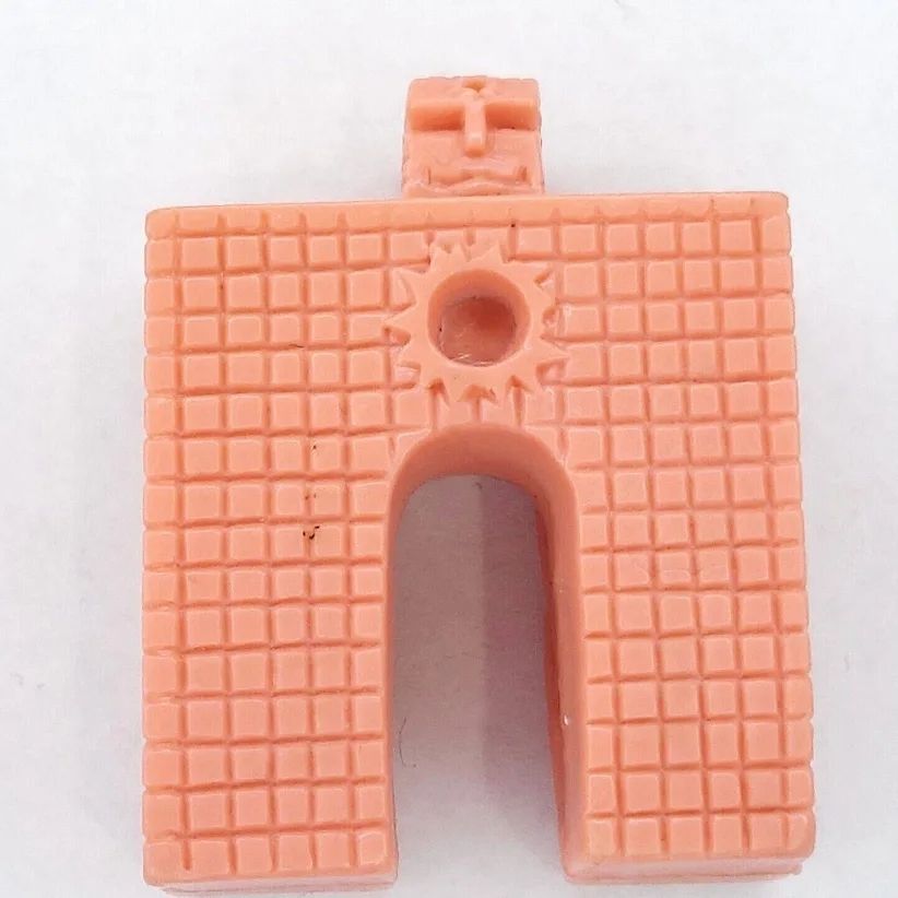 A particularly odd Muscle Man figurine, shaped like a stone arch or something