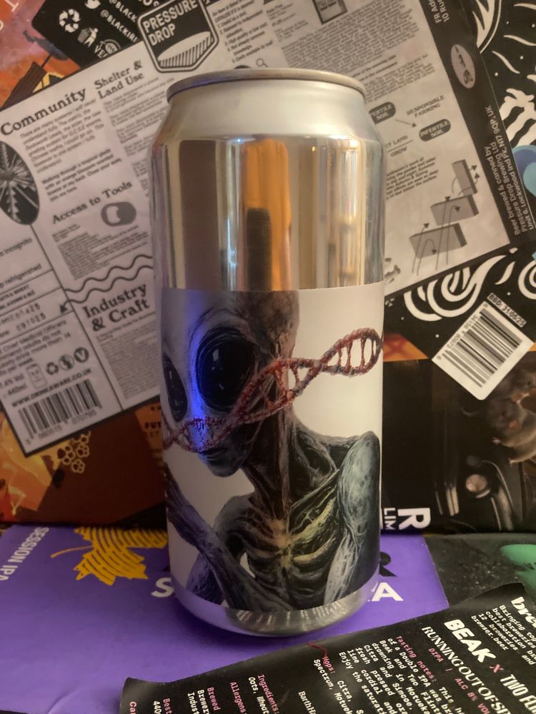 A weird looking can with an alien on the front. 