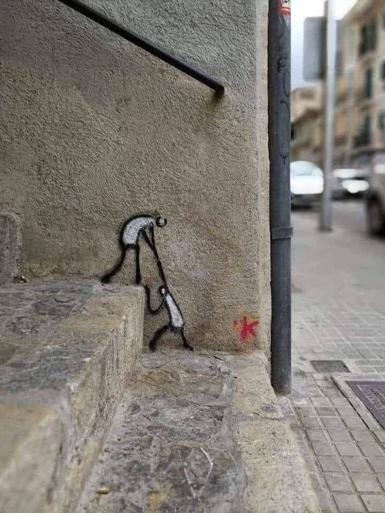 Grafitti pic of someone pulling up another person to the next step EU, Europe, Street Urbanism
