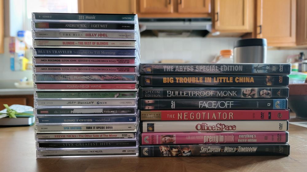 CDs:
311 - Music
Andrew WK - I Get Wet
Billy Joel - The Hits
Blondie - The Best of Blondie
Blues Traveler - Straight On Til Morning
Elton John - Goodbye Yellow Brick Road
The Flaming Lips - Embryonic
Fountains of Wayne - Fountains of Wayne
Green Day - Kerplunk!
Jeff Buckley - Grace
Nickelback - The Best of Nickelback
Save Ferris - Modified
Spin Doctors - Turn It Upside Down
Stevie Nicks - The Other Side of the Mirror
Styx - Greatest Hits
Weezer - Van Weezer

Movies:
The Abyss (Special Edition)
Big Trouble in Little China
Bulletproof Monk
Face/Off
The Negotiator
Office Space
Pretty in Pink (Everything's Duckie Edition)
Sky Captain and the World of Tomorrow