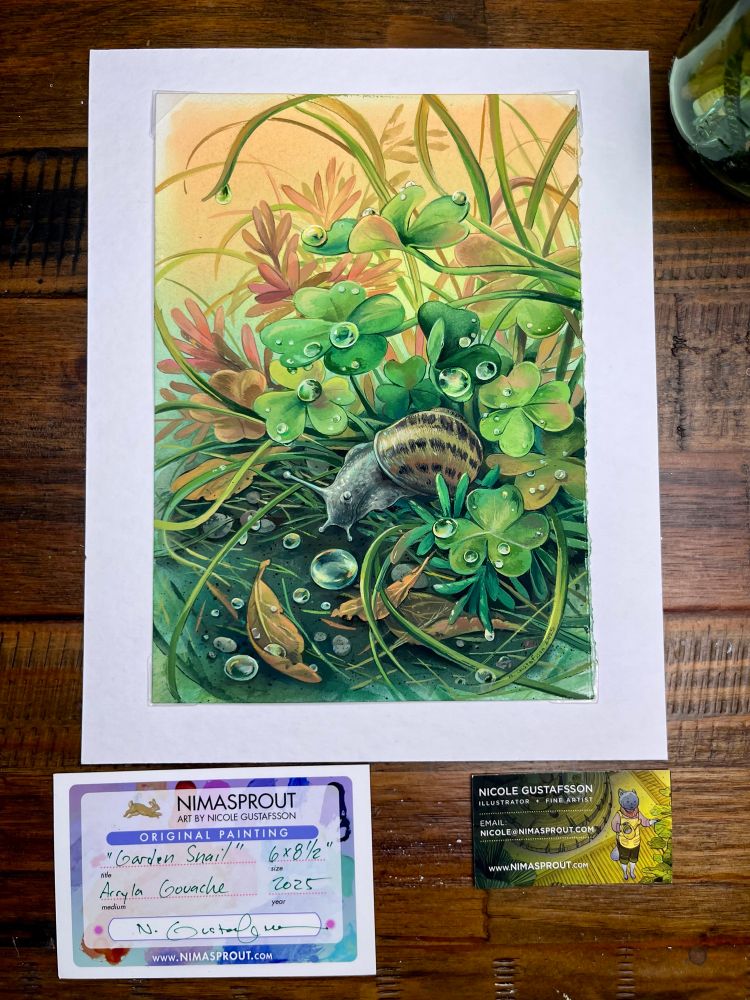 Top down photo of Nimasprout's Garden Snail painting on a wood desk. 

Below are two cards, 1st: "NIMASPROUT
ART BY NICOLE GUSTAFSSON
ORIGINAL PAINTING
"Garden Snail"
6×8½"
size
Acryla Gouache
2025"

2nd: "NICOLE GUSTAFSSON
ILLUSTRATOR + FINE ARTIST
EMAIL:
NICOLE@NIMASPROUT.COM
WWW.NIMASPROUT.COM"