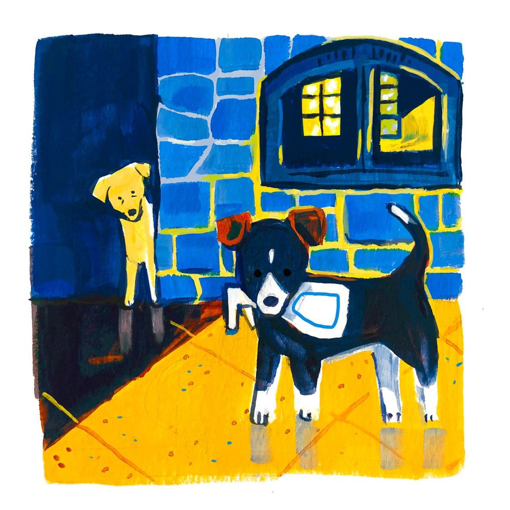 A black and white puppy (Leap) with brown ears holds a bottle of cleaner in her mouth. She stares at the camera, while a yellow lab (Flame) observes her nervously from behind a stone fireplace.