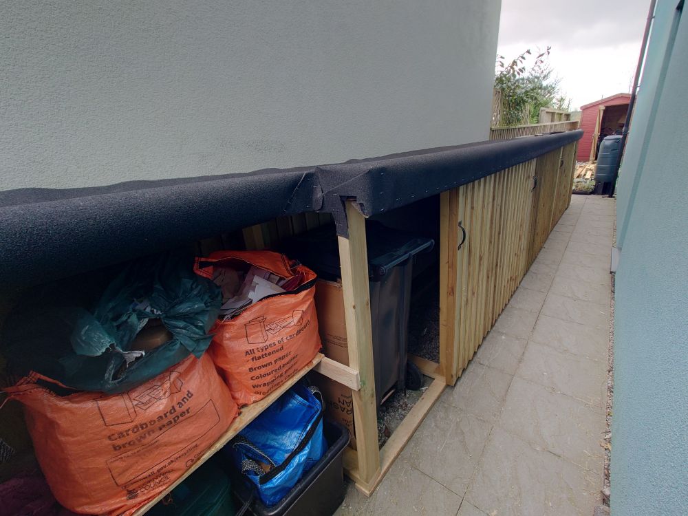 Video and images of a bike shed, with storage for other equipment and rollable doors. 