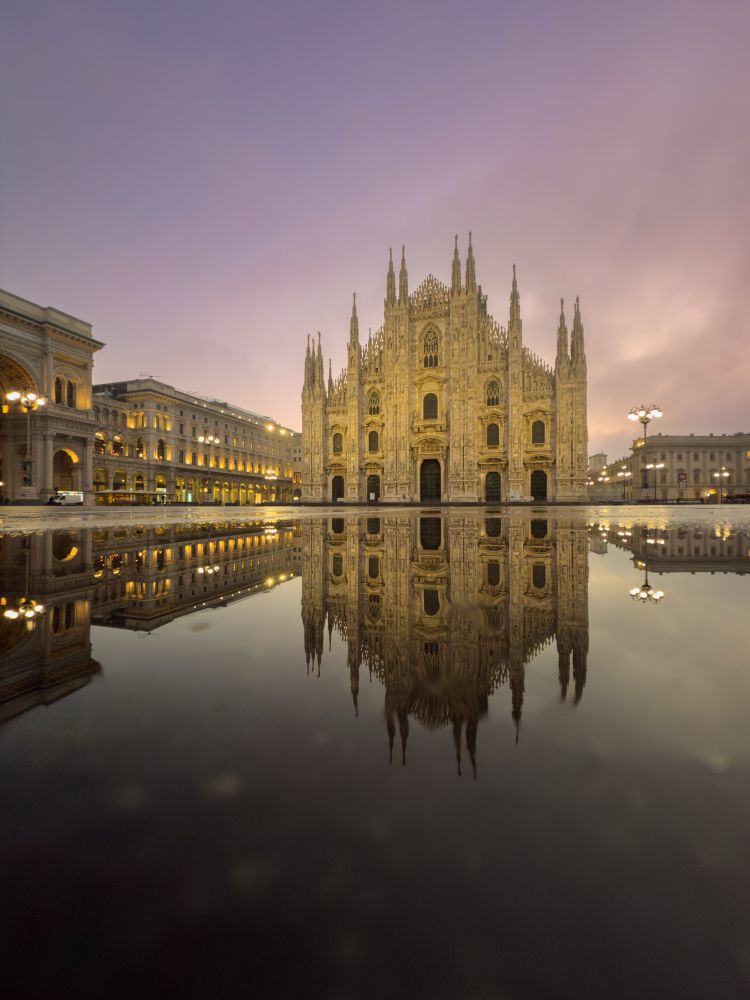 Photo of the floor cathedral at sunrise with a reflection of of the cathedral in a puddle of water 
