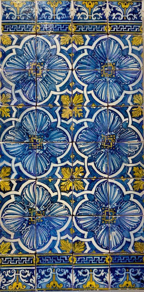 Beautiful blue and yellow floral designed tiles, known as azulejos, at the Tile Museum in Lisbon, Portugal.
