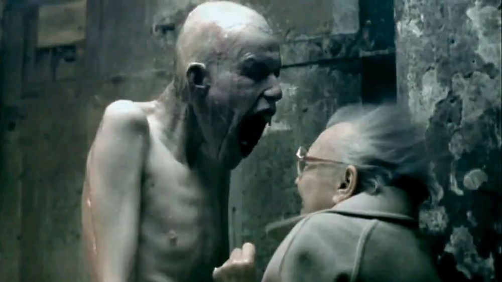 A pale tall hairless emaciated naked guy with a gaping maw gets right up in this old broad's face and screams so powerfully that it blows her hair back (from that Aphex Twin video)