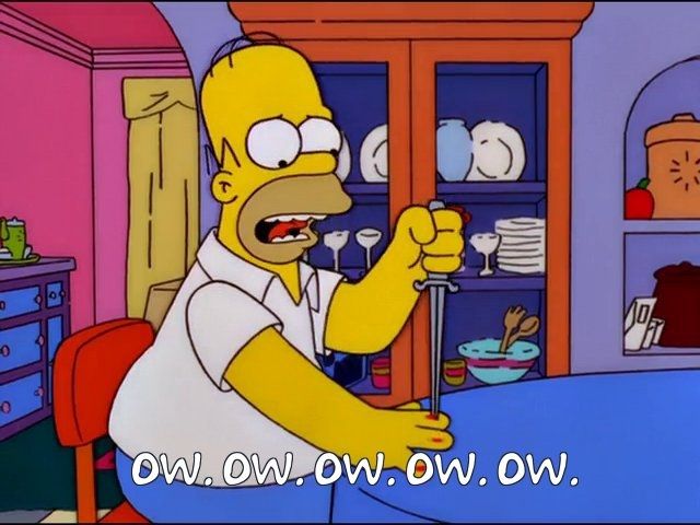 Homer Simpson playing the knife game at his kitchen table, and each of his fingers have a bloody red spot where he's stabbed each of them, and the knife is in his index finger (he is saying "Ow. Ow. Ow. Ow. Ow.")