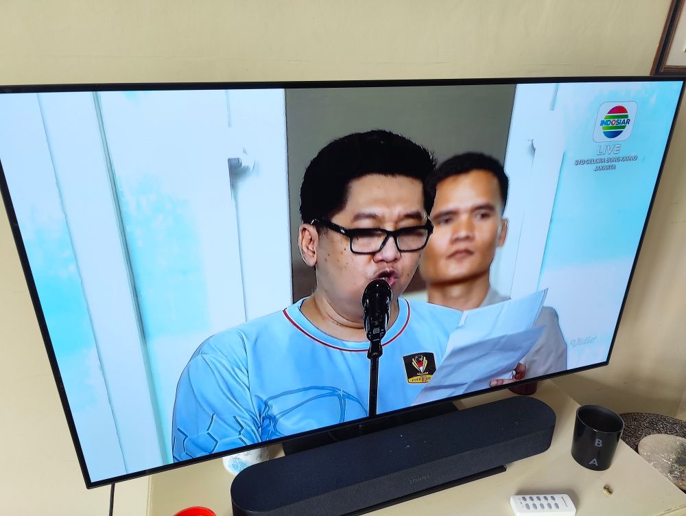 Oxford United in Indonesia, opening ceremony. Many reads speech into microphone.