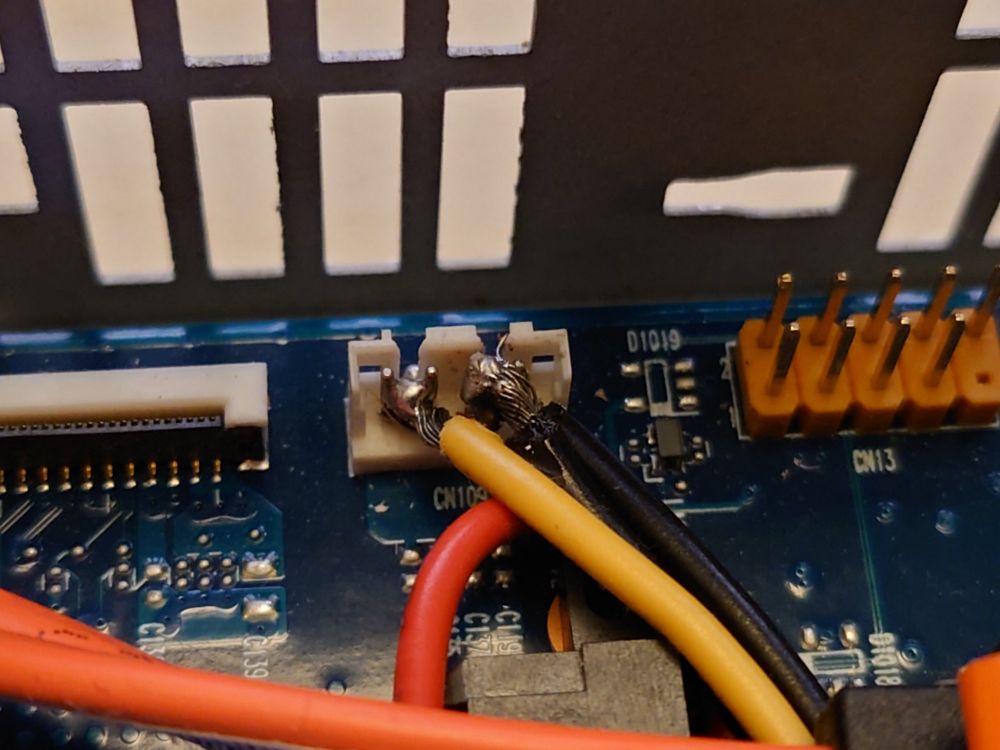 12V and ground wires soldered to another connector on the motherboard, less molten plastic this time