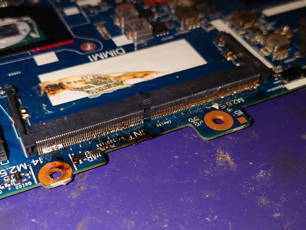 sodimm slot in the process of being soldered on, with lots of bridged pins and uneven joints