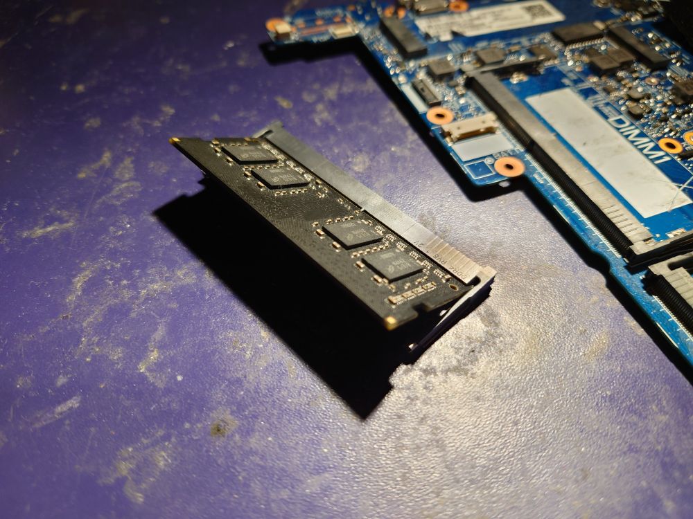 sodimm insterted into the unmounted slot at an angle, no longer held down by the retention clips