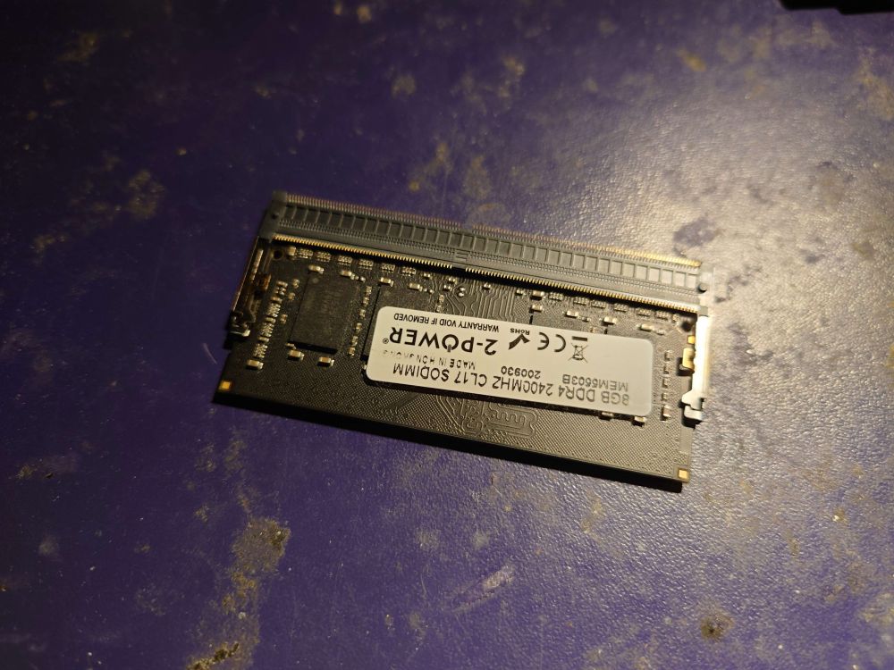 A DDR4 SODIMM memory module inserted into a DDR4 SODIMM memory slot that isn't soldered to a motherboard but just laying on my desk instead