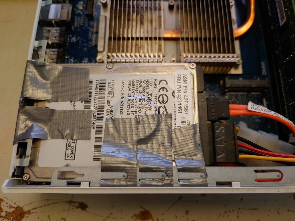 A 2.5" hard drive duct-taped to the inside of the case of a Cisco-rebranded Wyse thin client