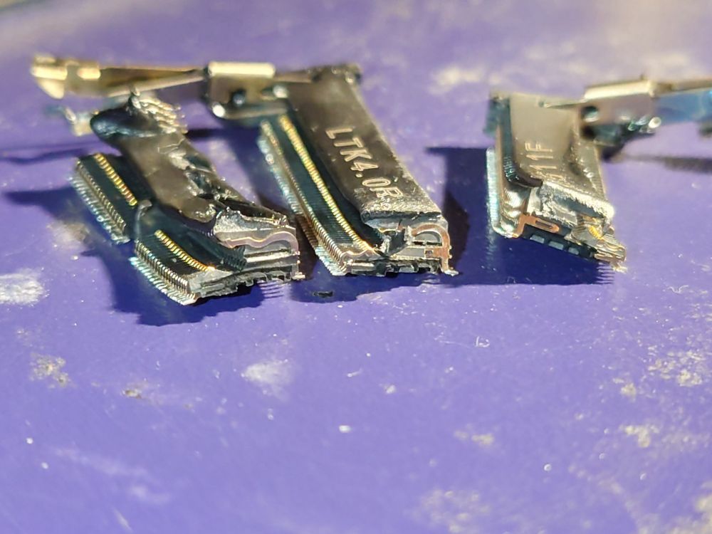 side view of various pieces of the desoldered ram slot, showing a cross-section of the inside