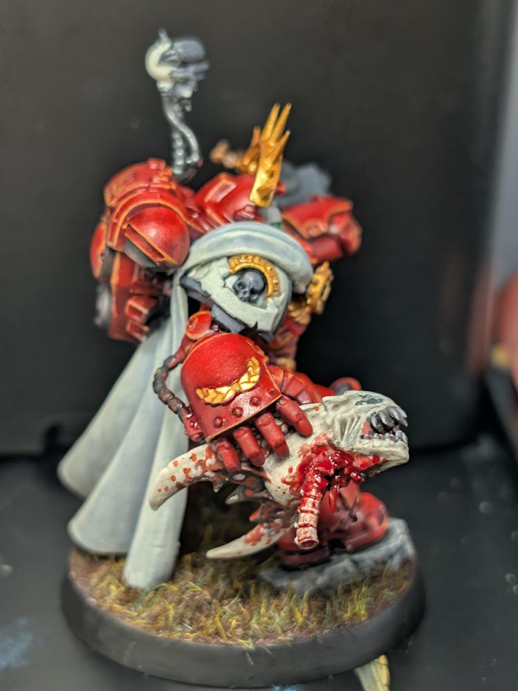 The gooppy side of a tyranid warrior being held by a grav captain
