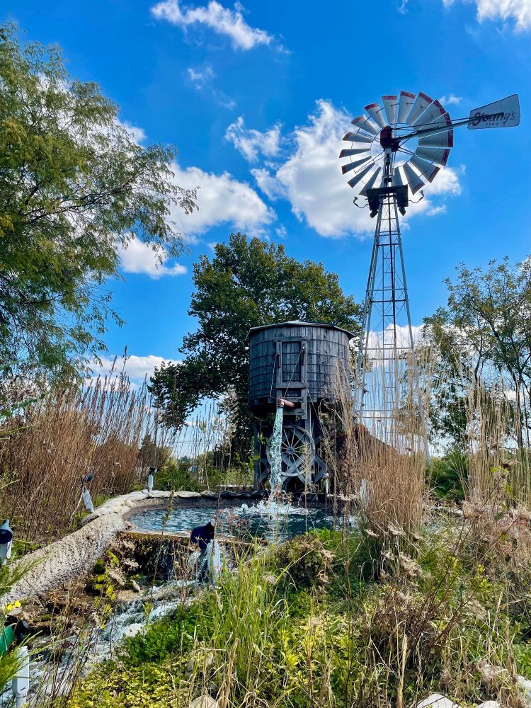 a small water tower and fountain water feature on a putt putt course