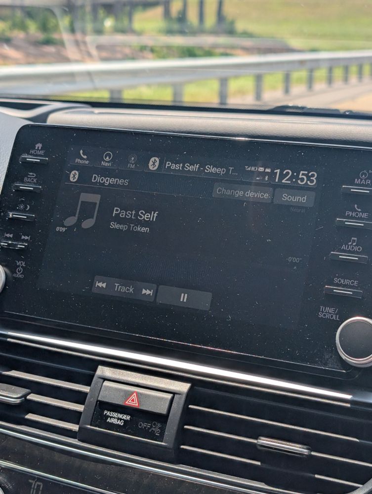 a car dash screen that says "Past Self" by Sleep Token is playing