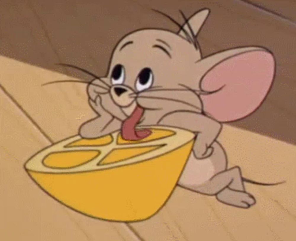 a cartoon mouse is holding a slice of lemon .