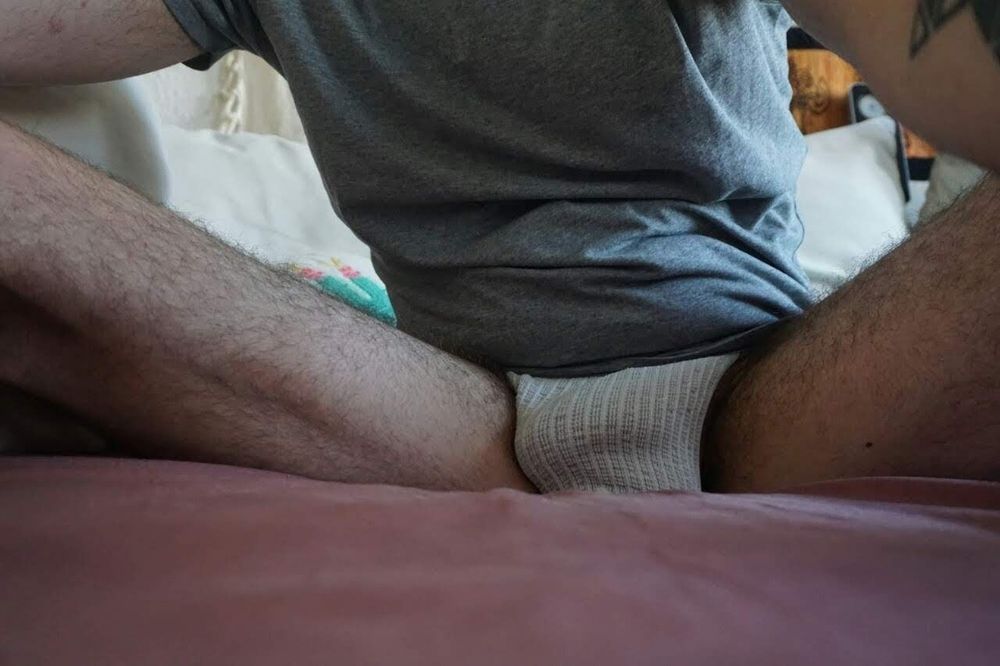 Sitting on a couch with a tshirt and jockstrap