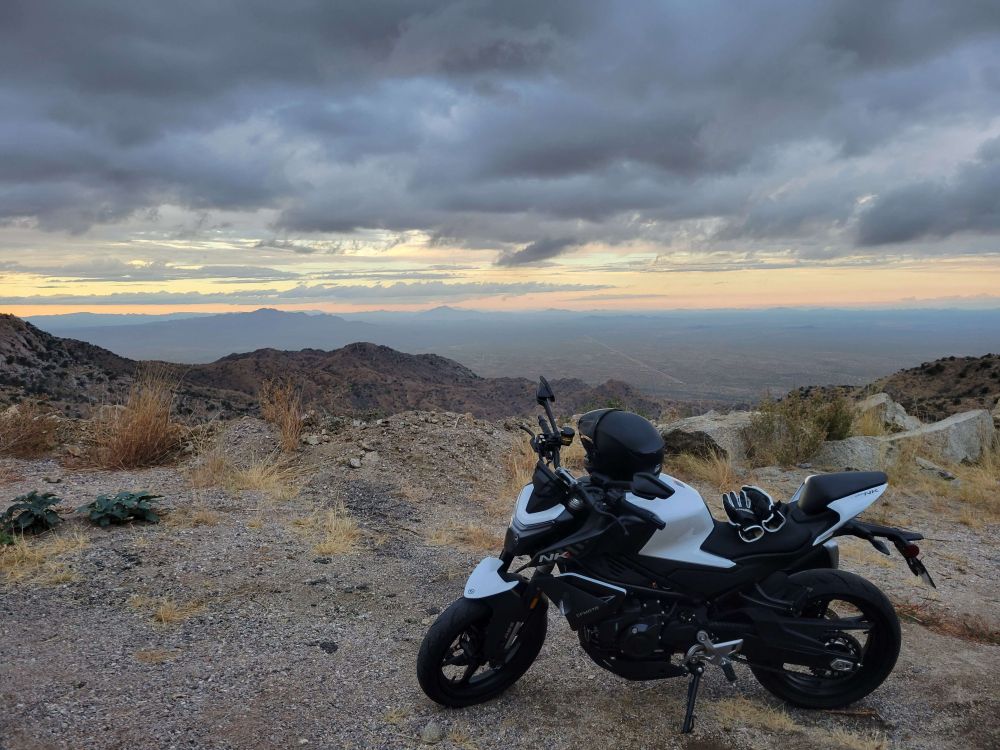 My parked motorcycle on the shoulder of the road leading to the peak of a local mountain