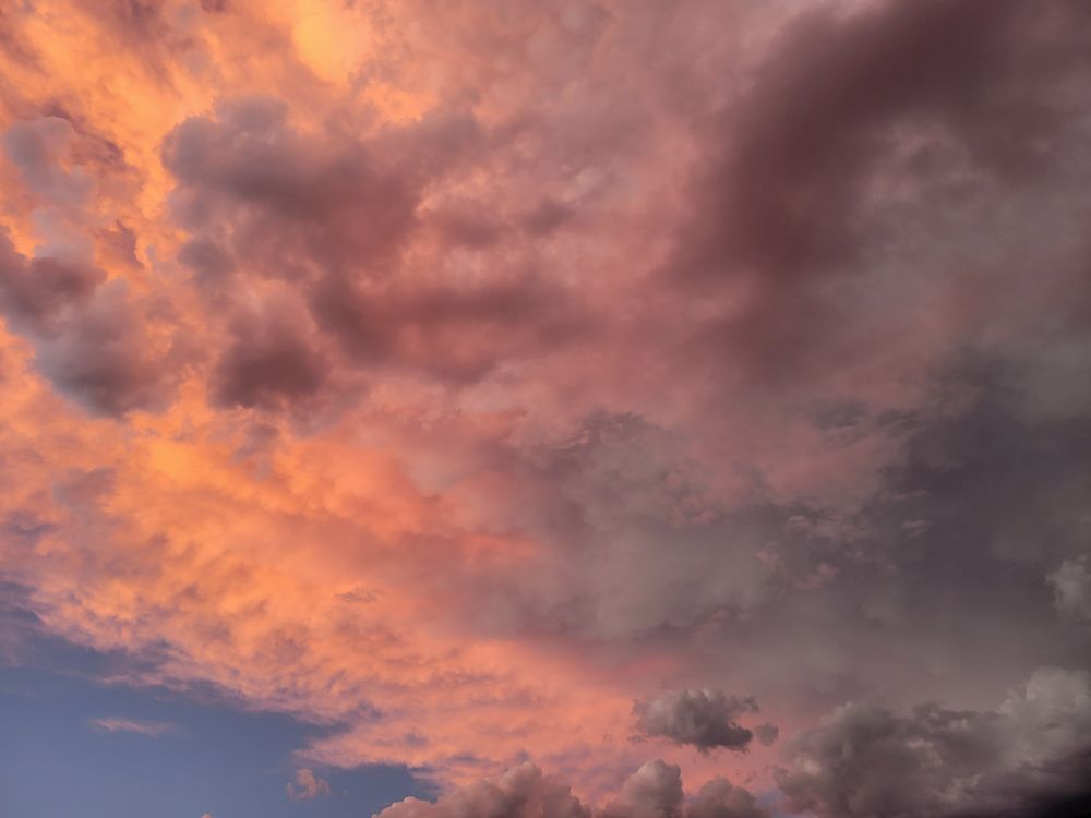 A pink, red, and yellow sunset reflecting off clouds in the Southern Arizona sky