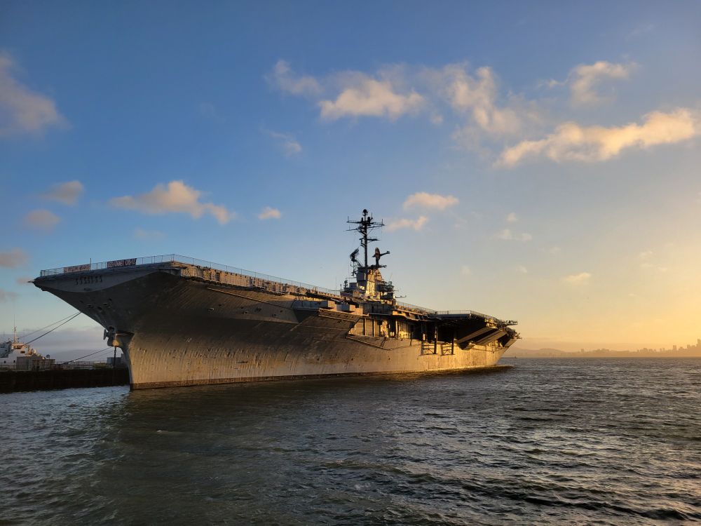The U.S.S Hornet aircraft carrier in the setting sunlight