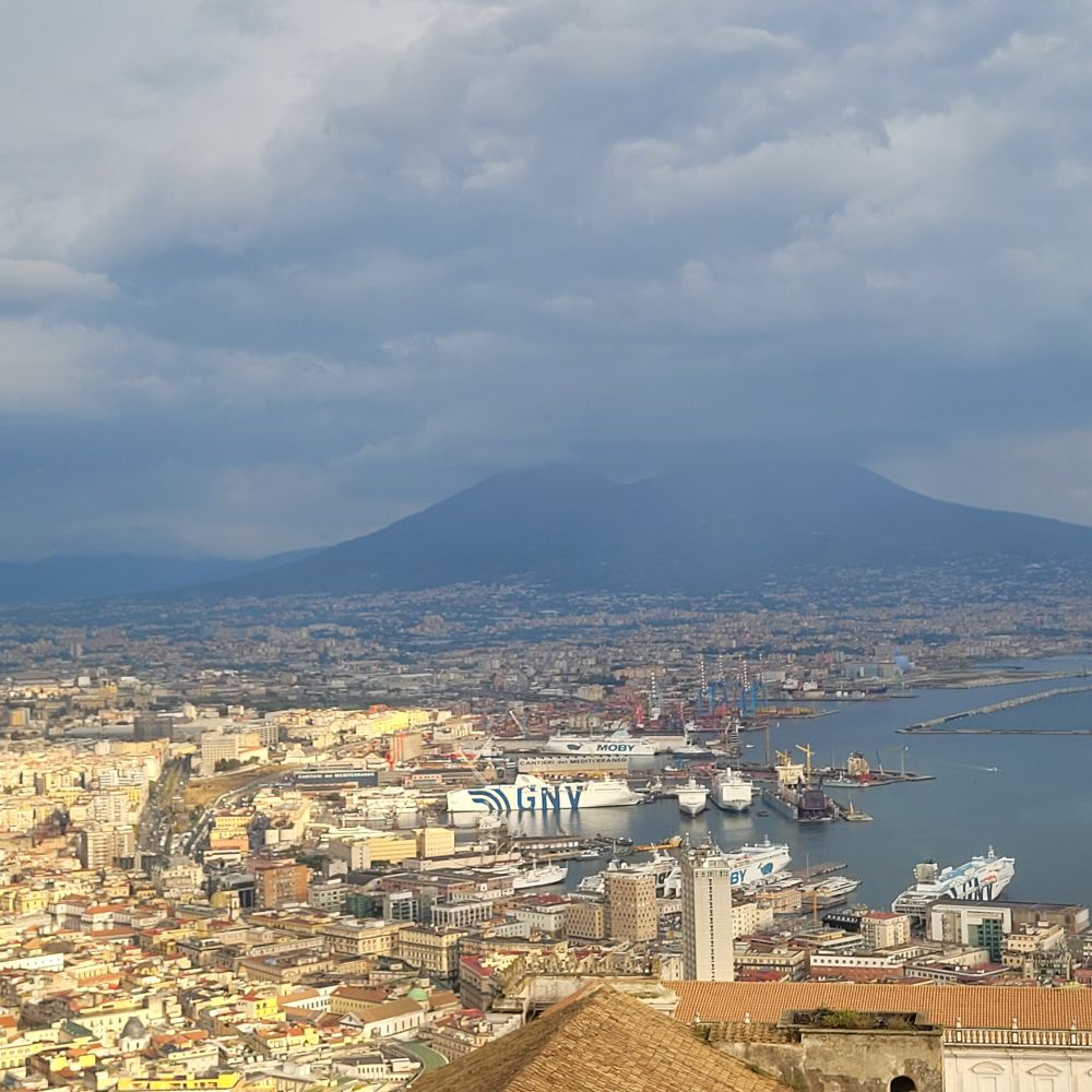 Sunny Naples and cloudy Mount Vesuvius in the background