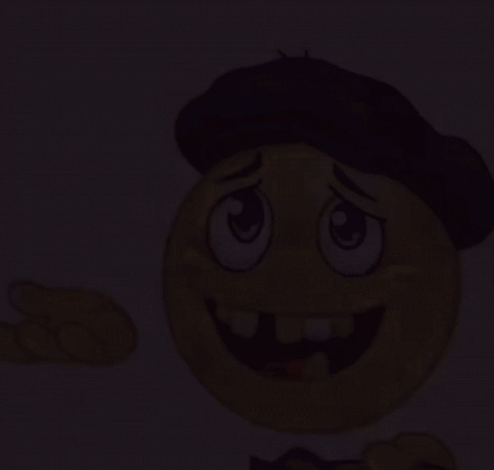 a cartoon smiley face wearing a brown hat is smiling and pointing