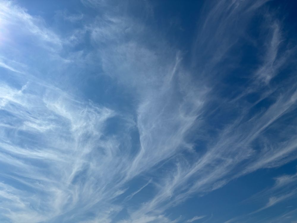 Photograph of wispy clouds against a blue sky