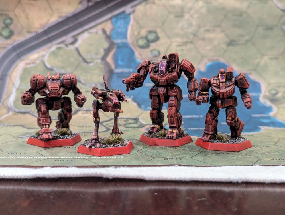 Low front angle of a Dragon, Locust, Battle Master, and Wolverine painted in the house colors of the Draconis Combine.