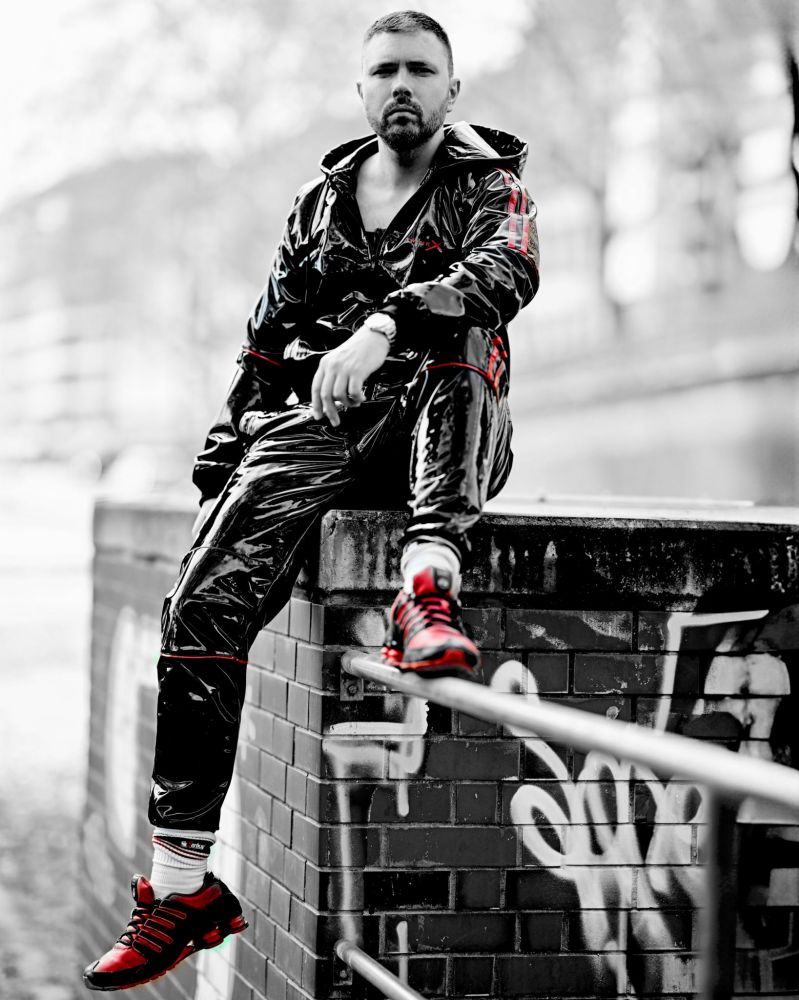 Man in shiny tracksuit, leather bulldog harness and Shox NZ1