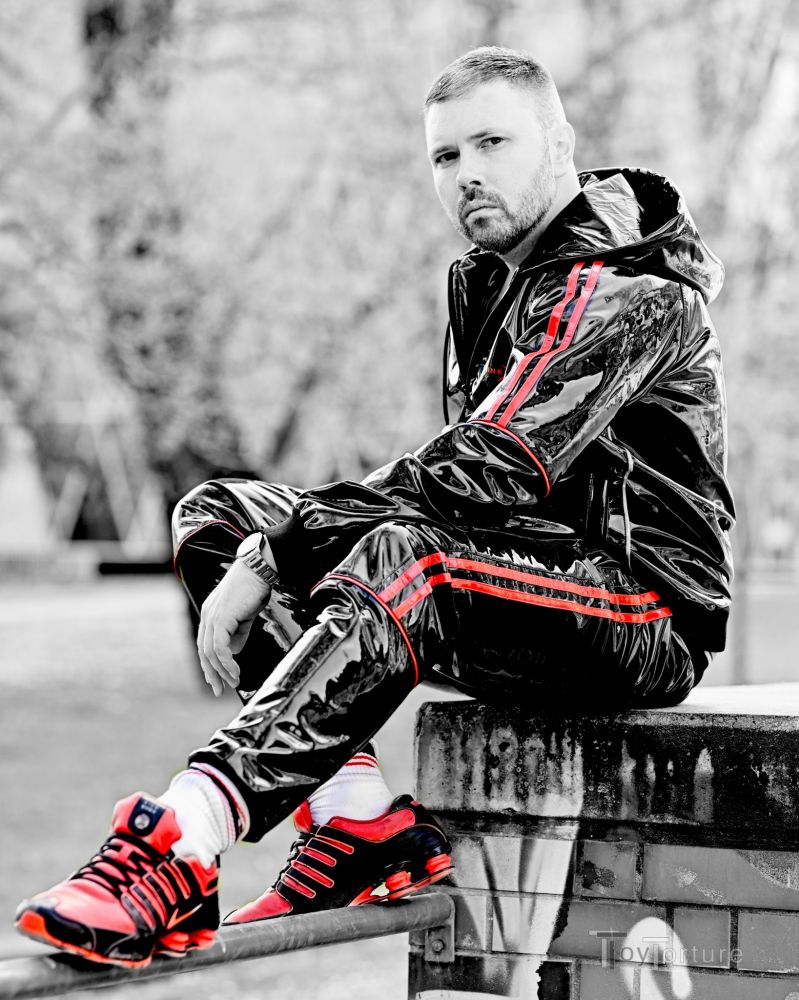 Man in shiny tracksuit, leather bulldog harness and Shox NZ1