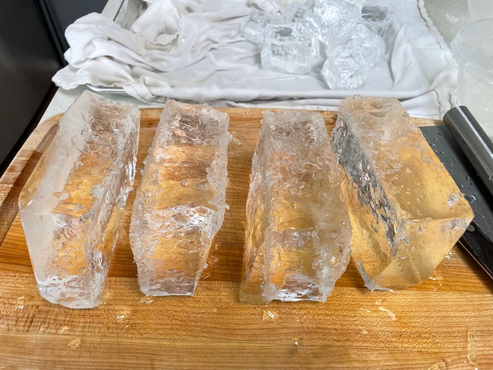 A block of clear ice cut into long thin strips