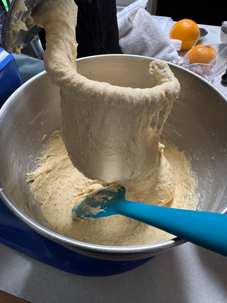A mixer full of dough for orange rolls