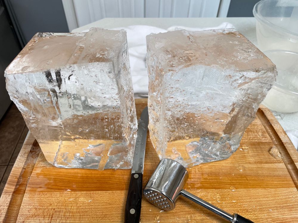 A block of clear ice cleaved in half