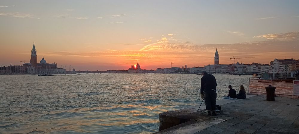 Sun setting behind punta della dogana in Venice 