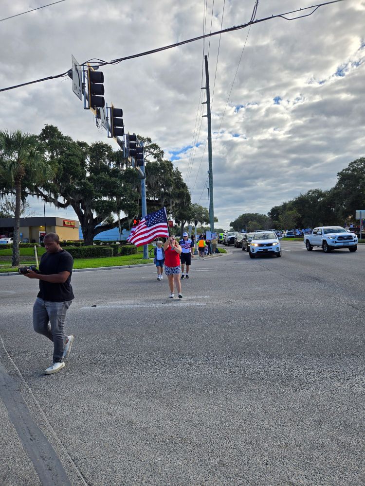 Woman walking waving American flag
