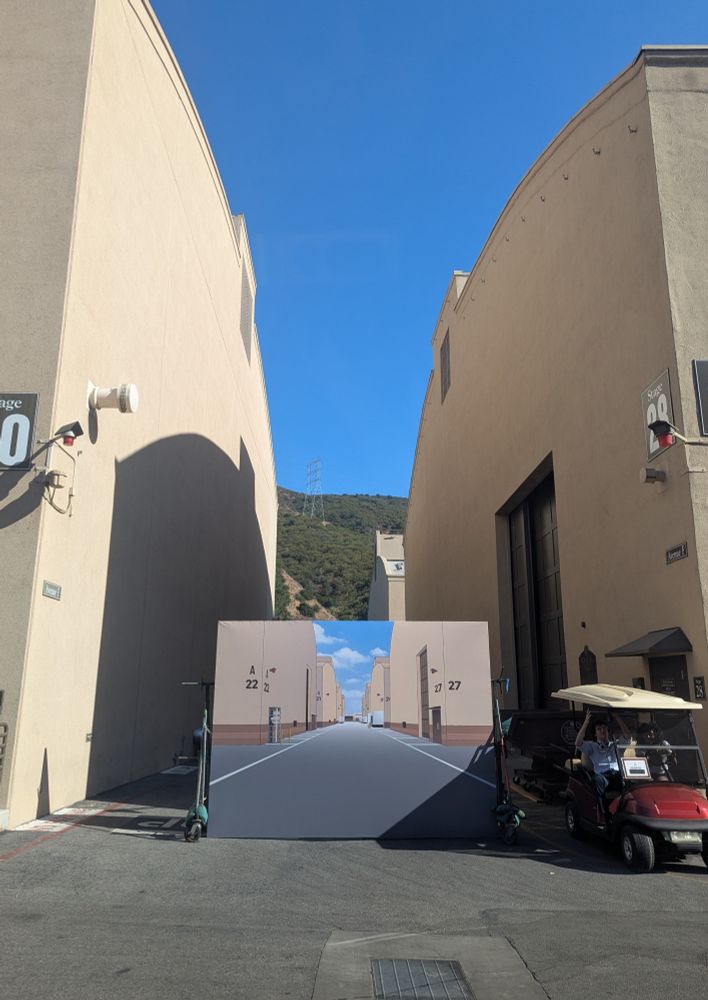 A Looney Tunes-esque illusion matte painting in front of WB soundstages