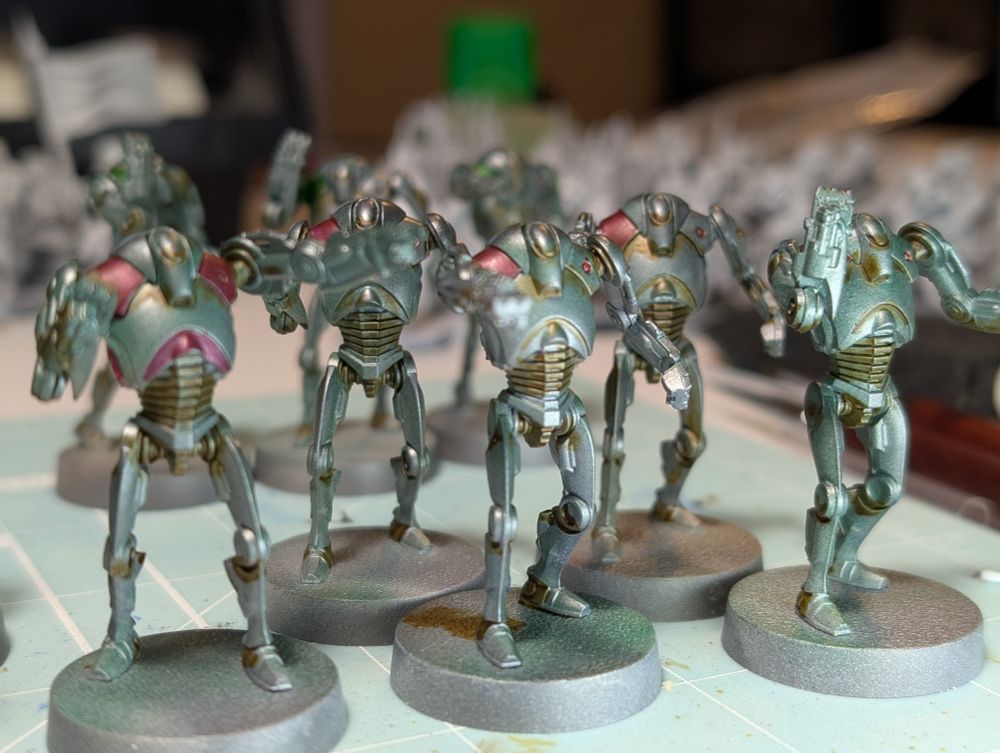 A squad of metal rusted robots with red shoulders for Red Squad!